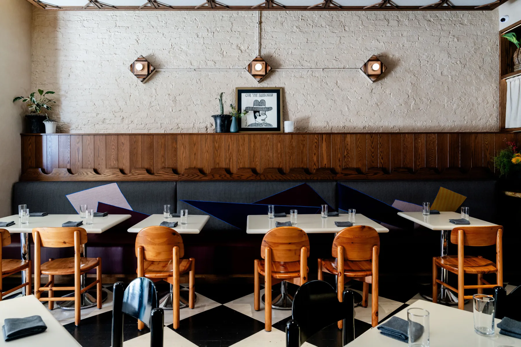 The dining room at Creepies: banquettes, a checkerboard floor and a coffered ceiling.