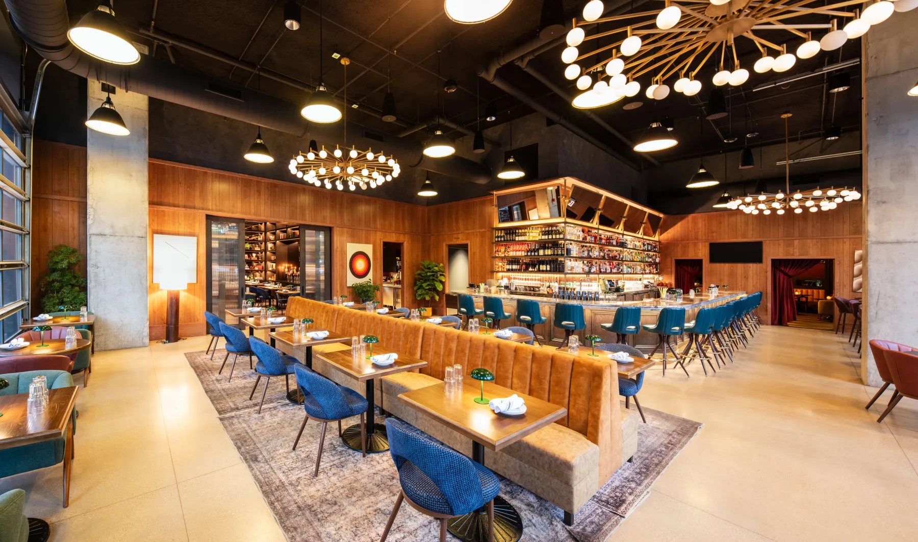 DJ's Great Room: a long banquette, a blue-stooled bar and large globe chandeliers.