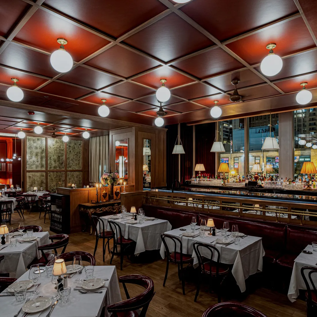 Petit Pomeroy: a red coffered ceiling with globe lights over white tablecloths.