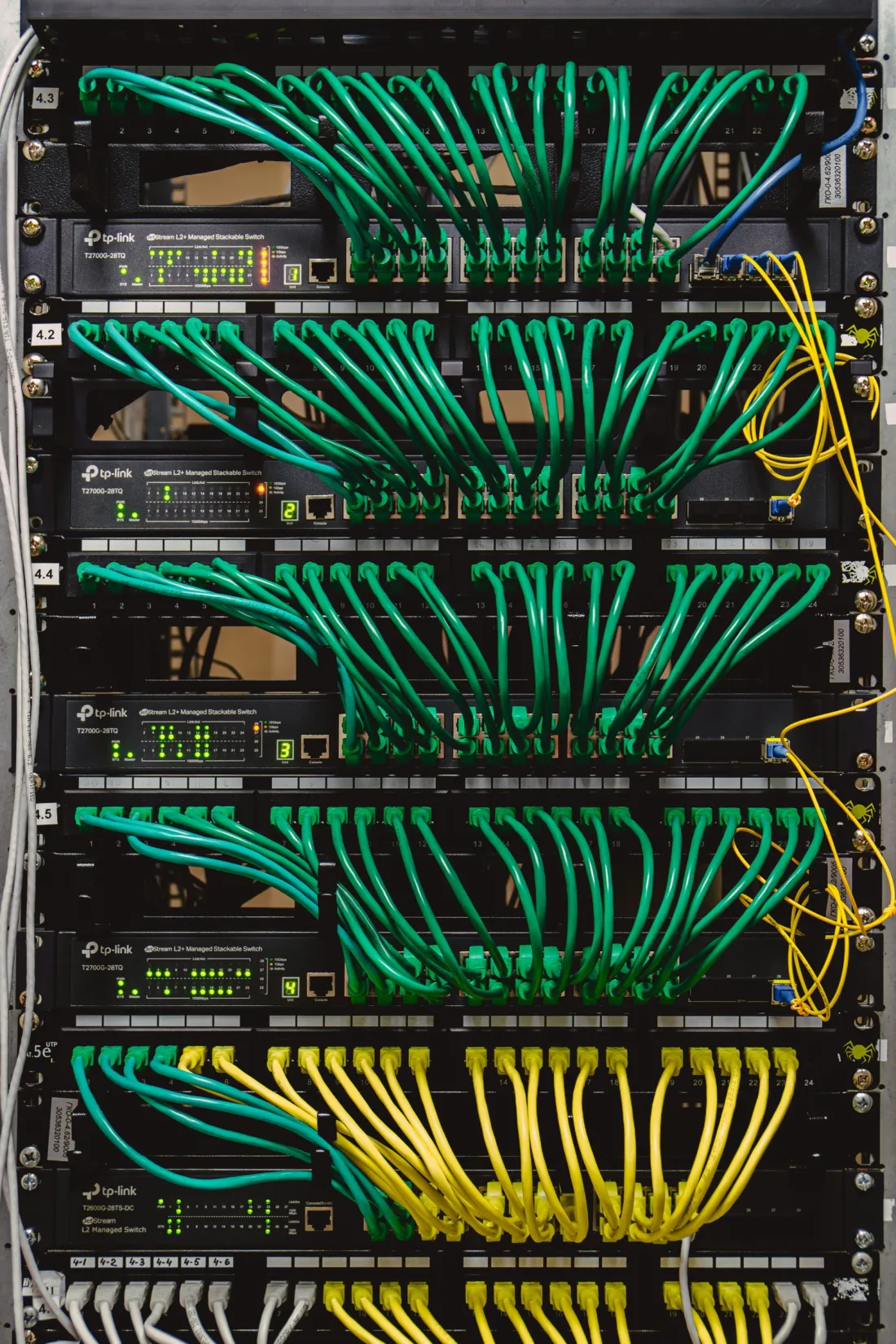 An r:home equipment rack with neatly dressed network cables.